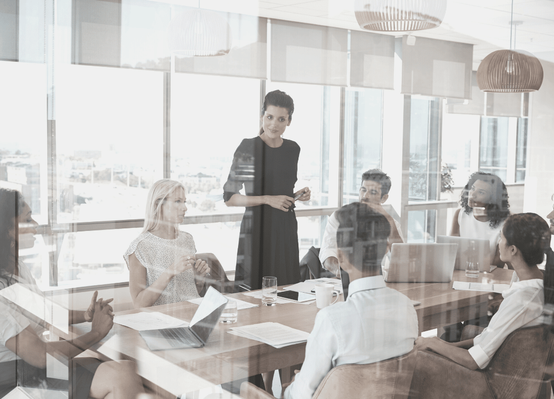 5 ways to improve your leadership skills. Woman talking in meeting.