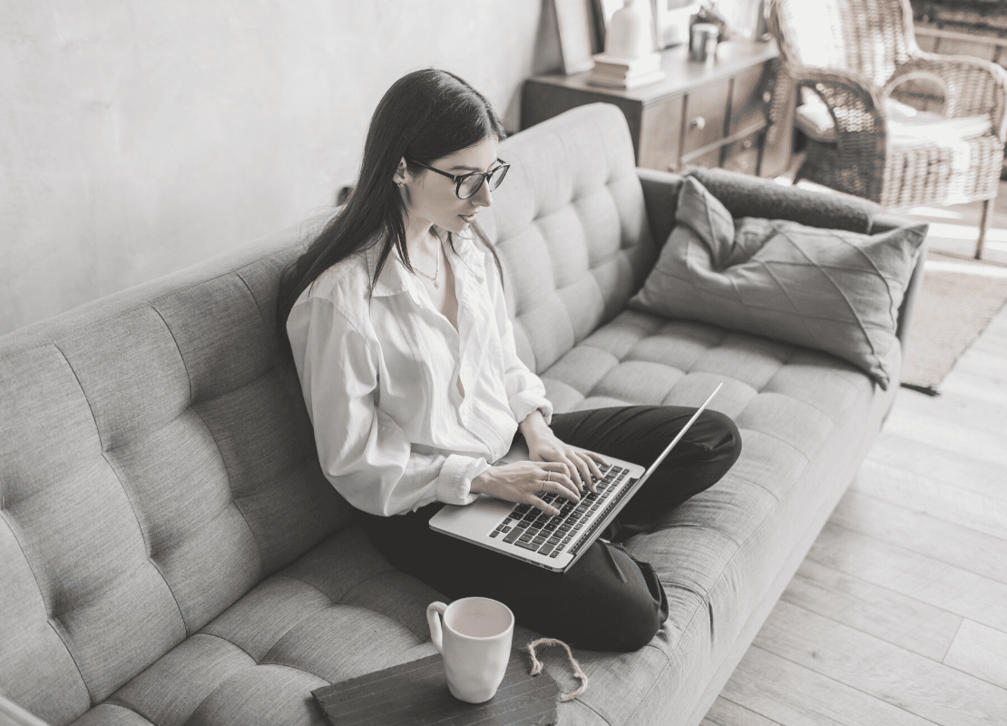 10 tools to help you work remotely. Woman working from sofa with laptop.