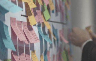 Communicating your priorities better with the 'rule of five'. Post-it notes on a wall.